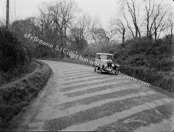 OLD CAR ON COUNTRY ROAD